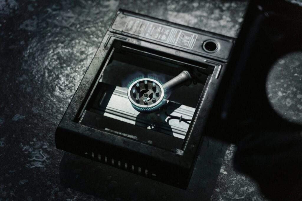 Portable single burner gas stove being used to cook pasta outdoors